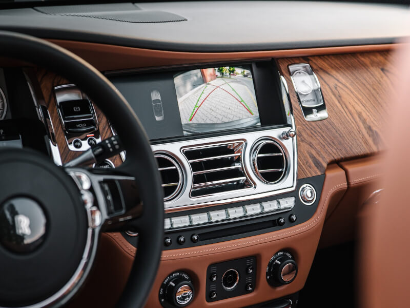 Car dashboard with wood paneling.