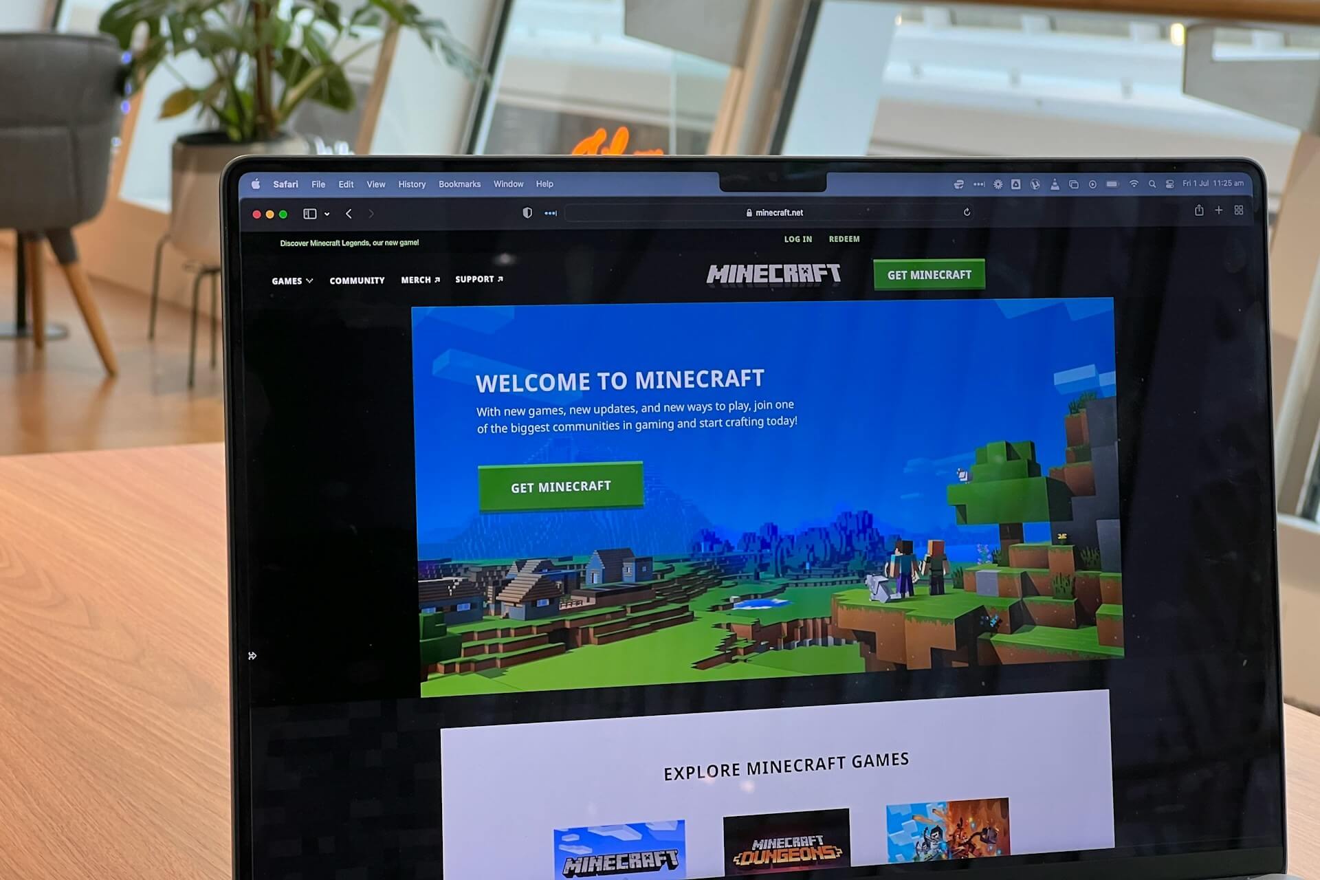 A Macbook with the Minecraft website on the screen