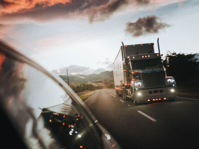 Truck on the road, late day.