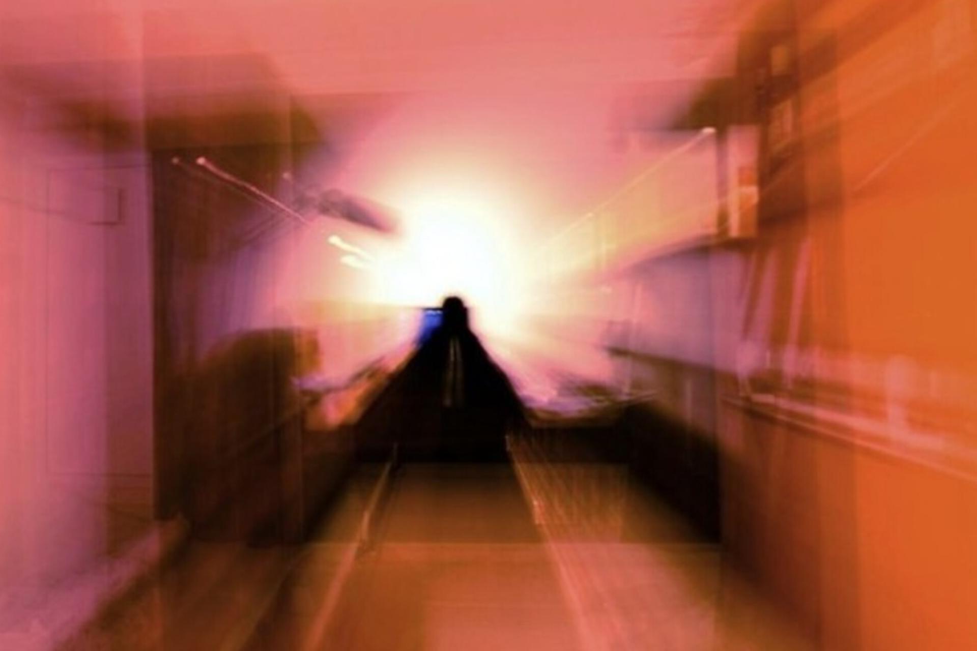 Hazy orange image of a silhouetted figure