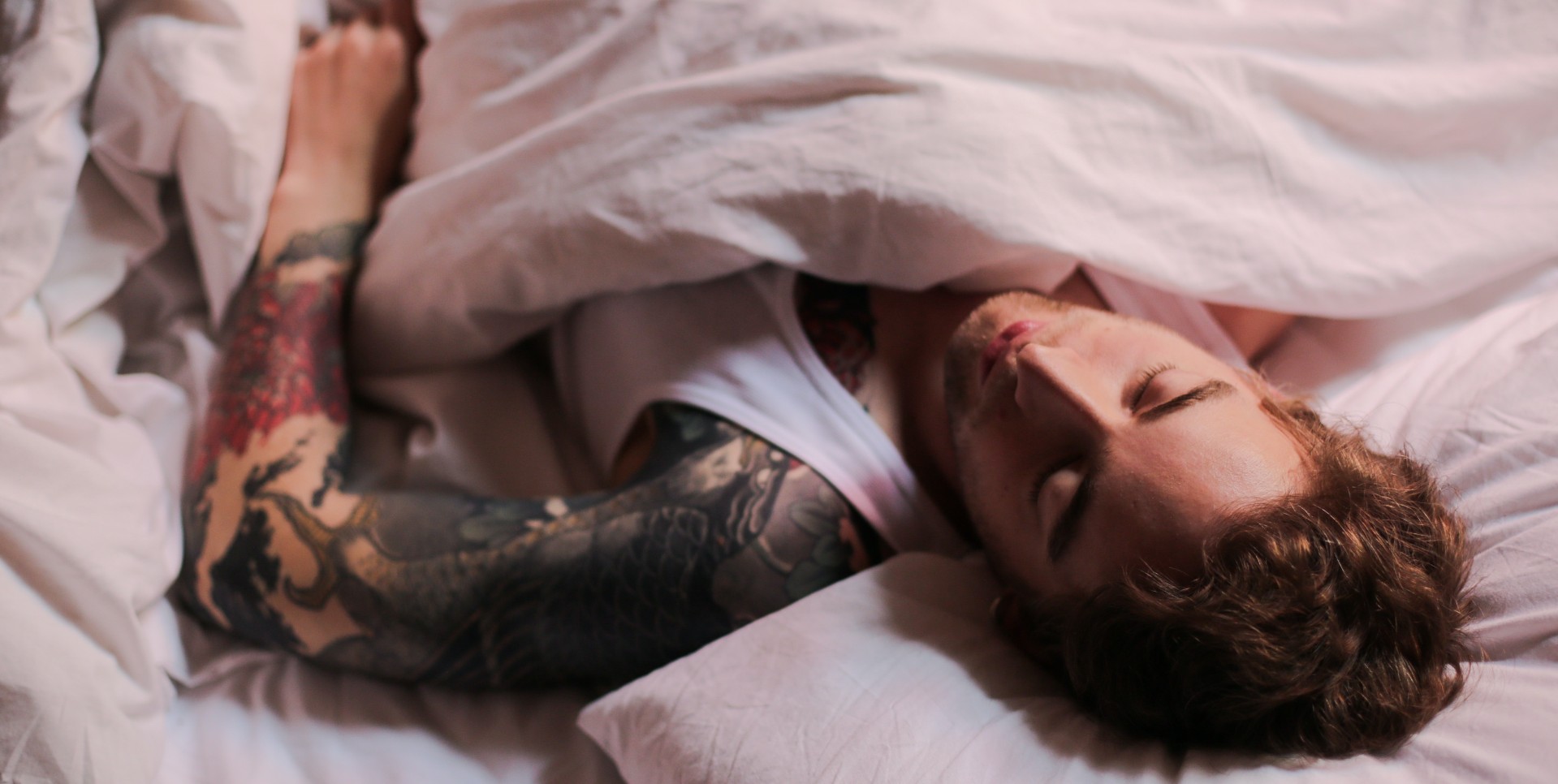 A man asleep in a bed