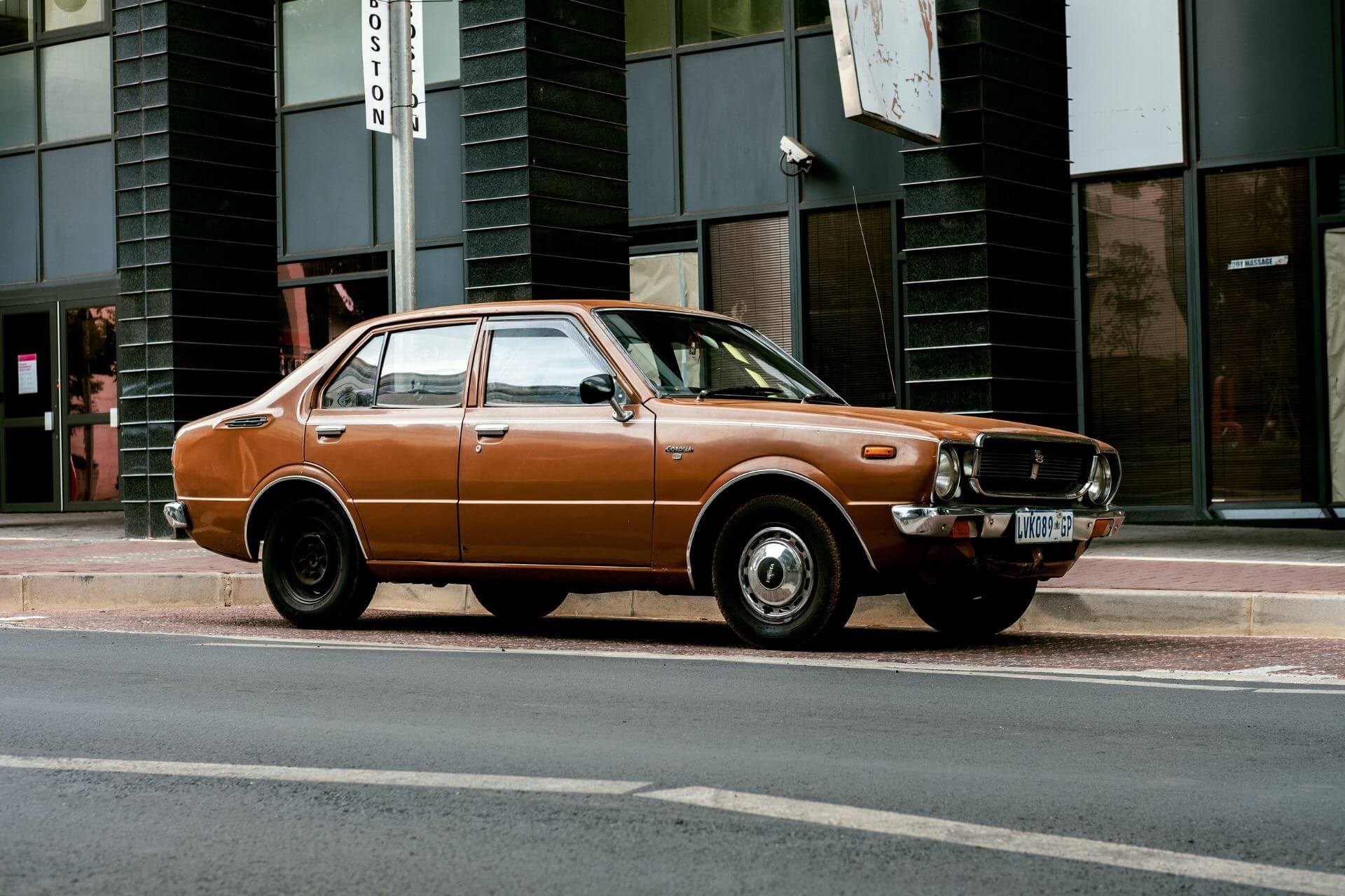 Brown sedan parked on the street