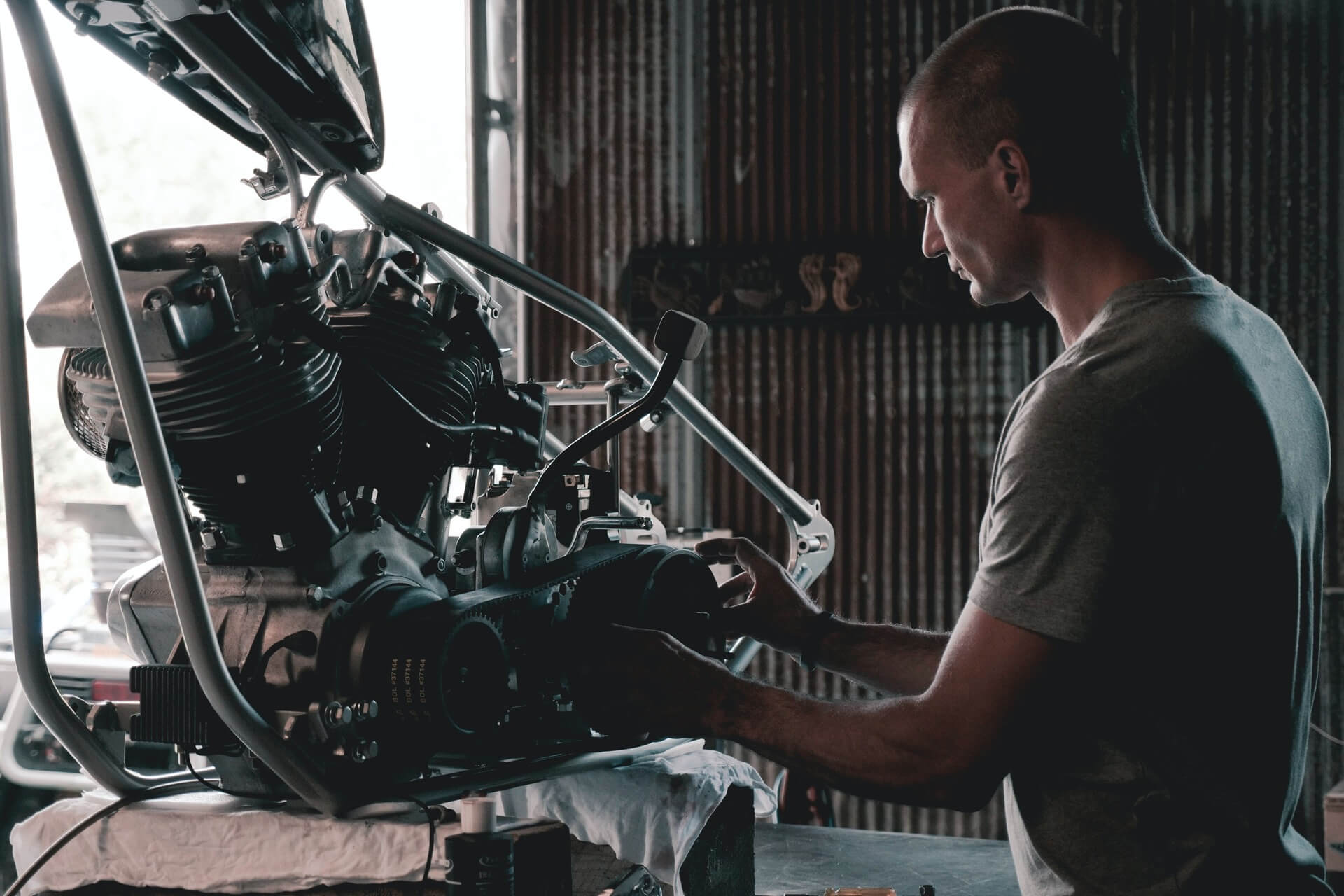 A mechanic working on a removed alternator