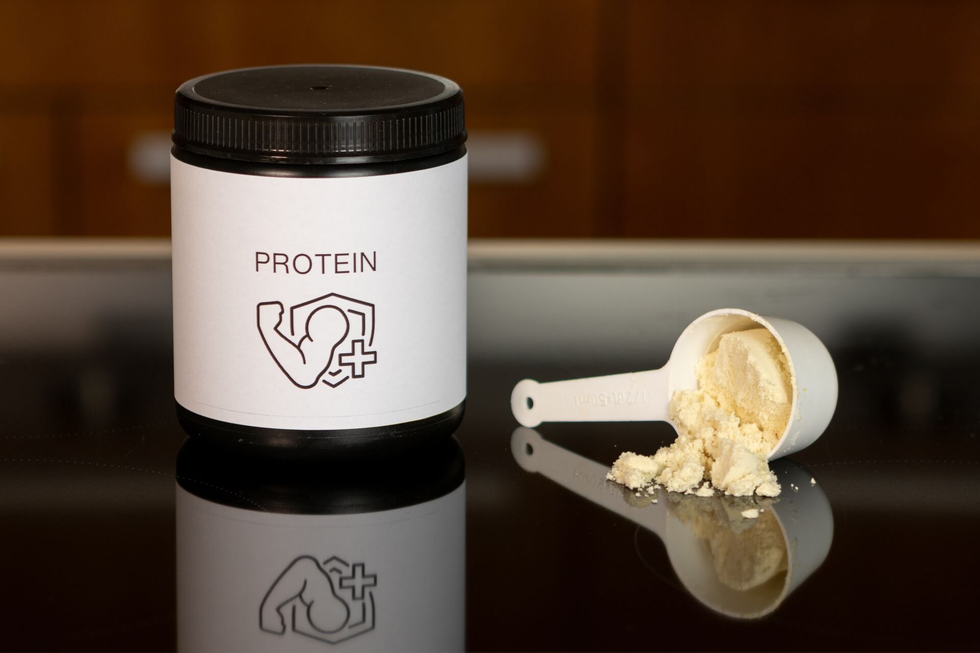 Tub of protein powder with a scooper