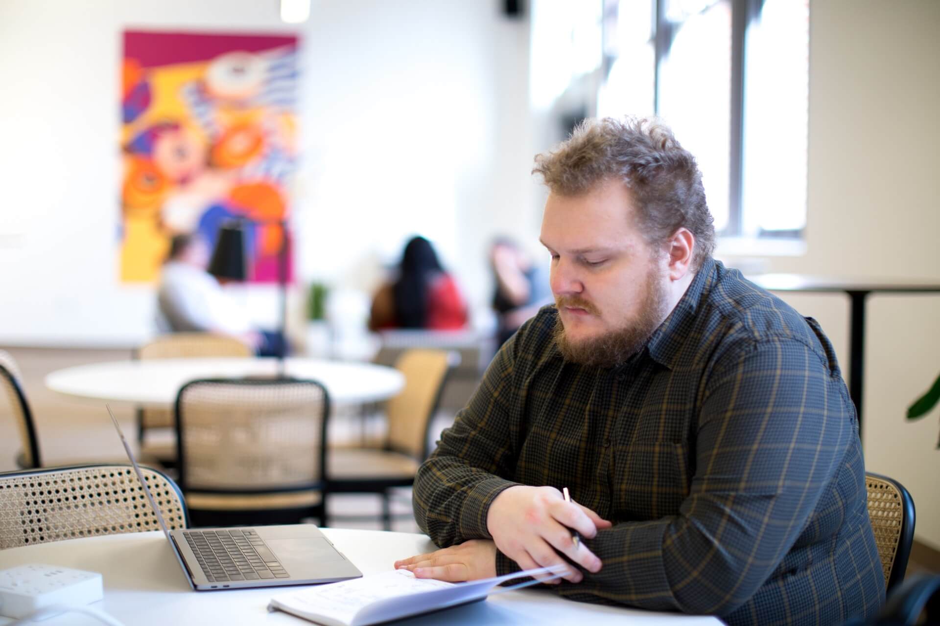 Obese man sitting alone while reading something