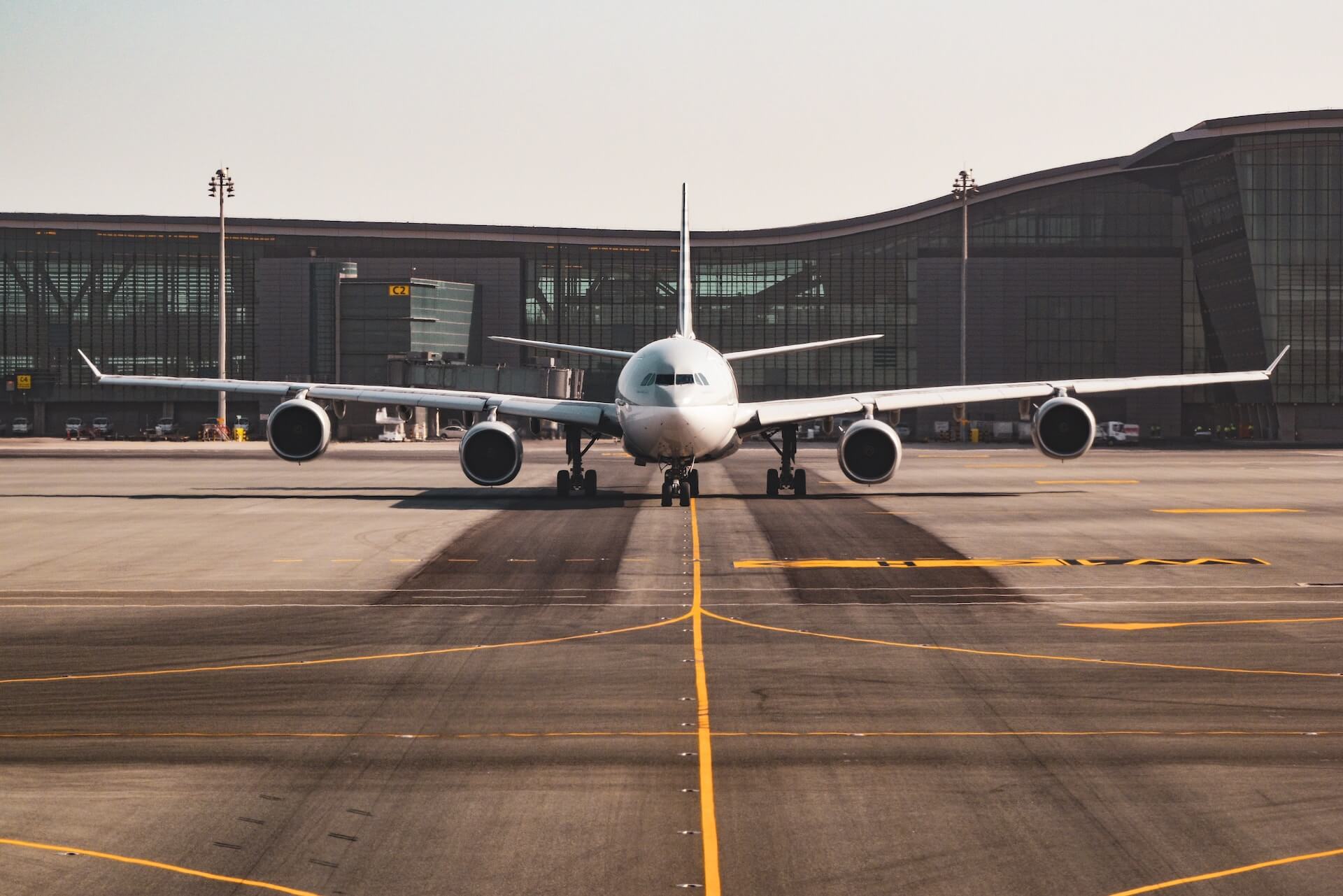 White airplane sits on the runway.