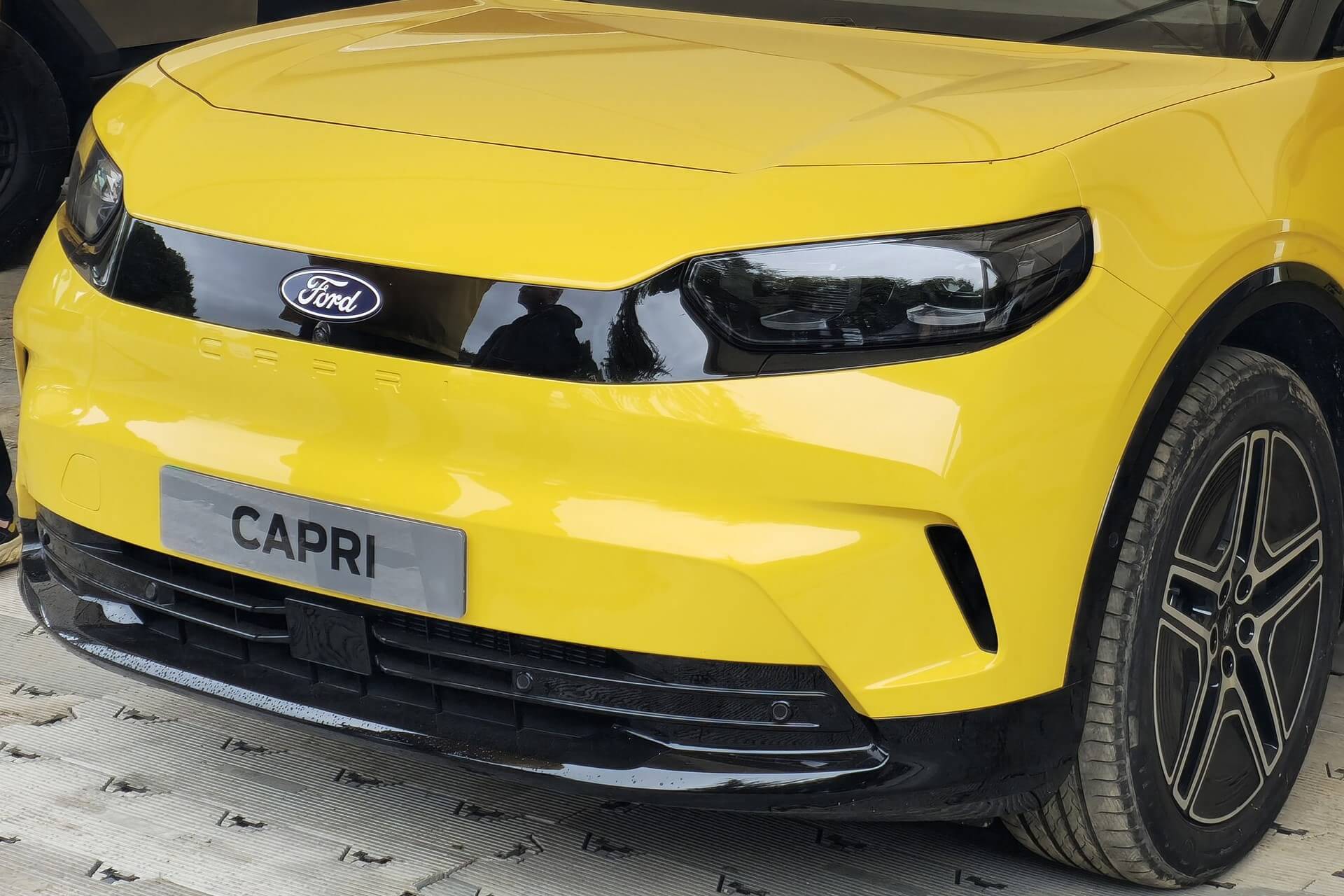 A yellow 2024 Ford Capri EV on display