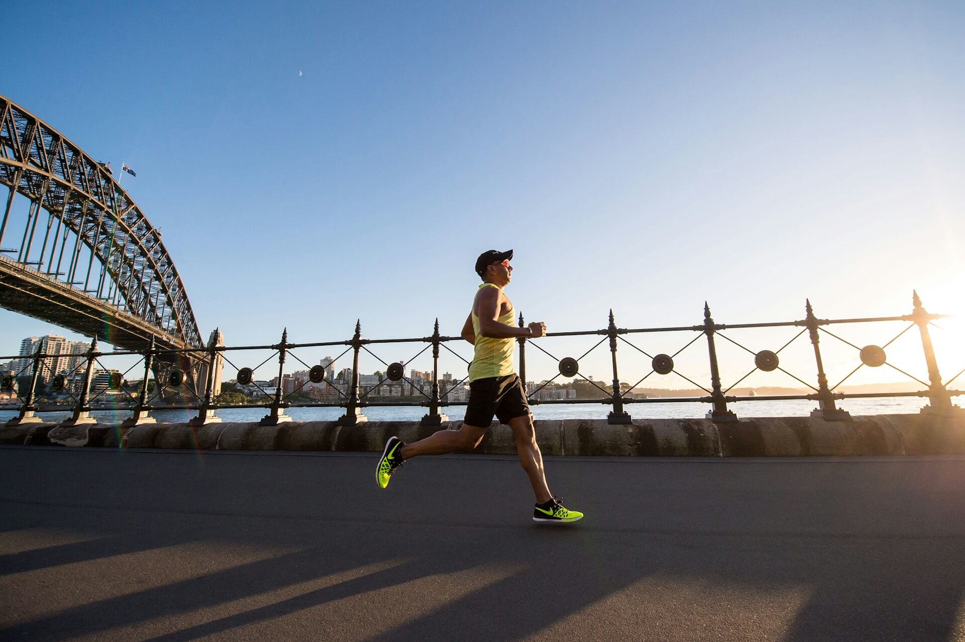 Man in athletic gear runs through the city.