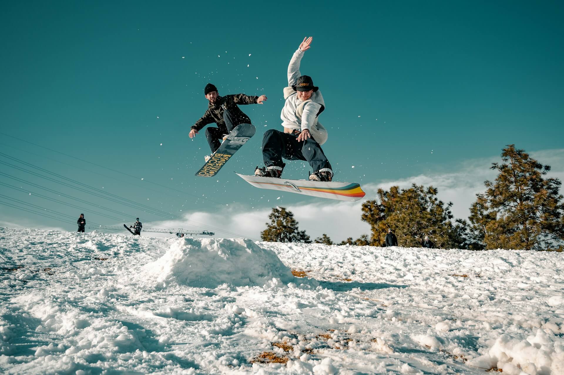 Two people riding snowboards on a slope