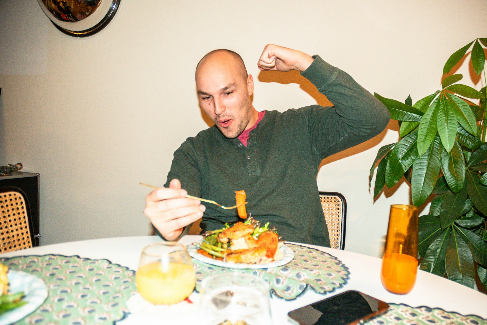 A man excitedly eating from a loaded plate