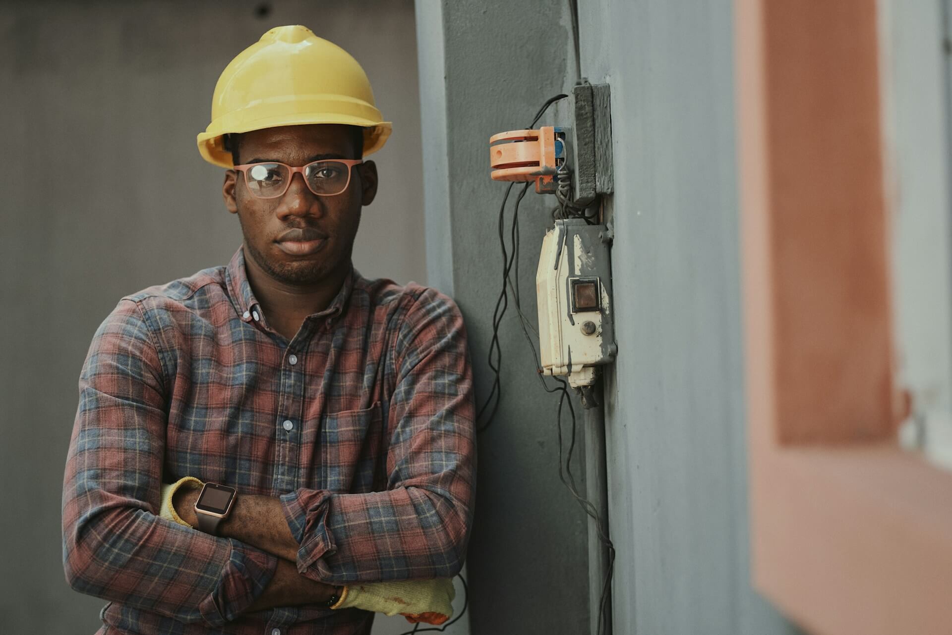 Man with plaid shirt and construction hat on