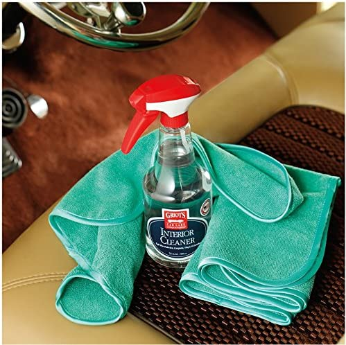 Bottle of interior cleaner with green cloth.