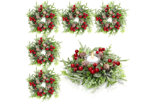 a collection of elaborate garland centerpieces, one of which has a candle in the center