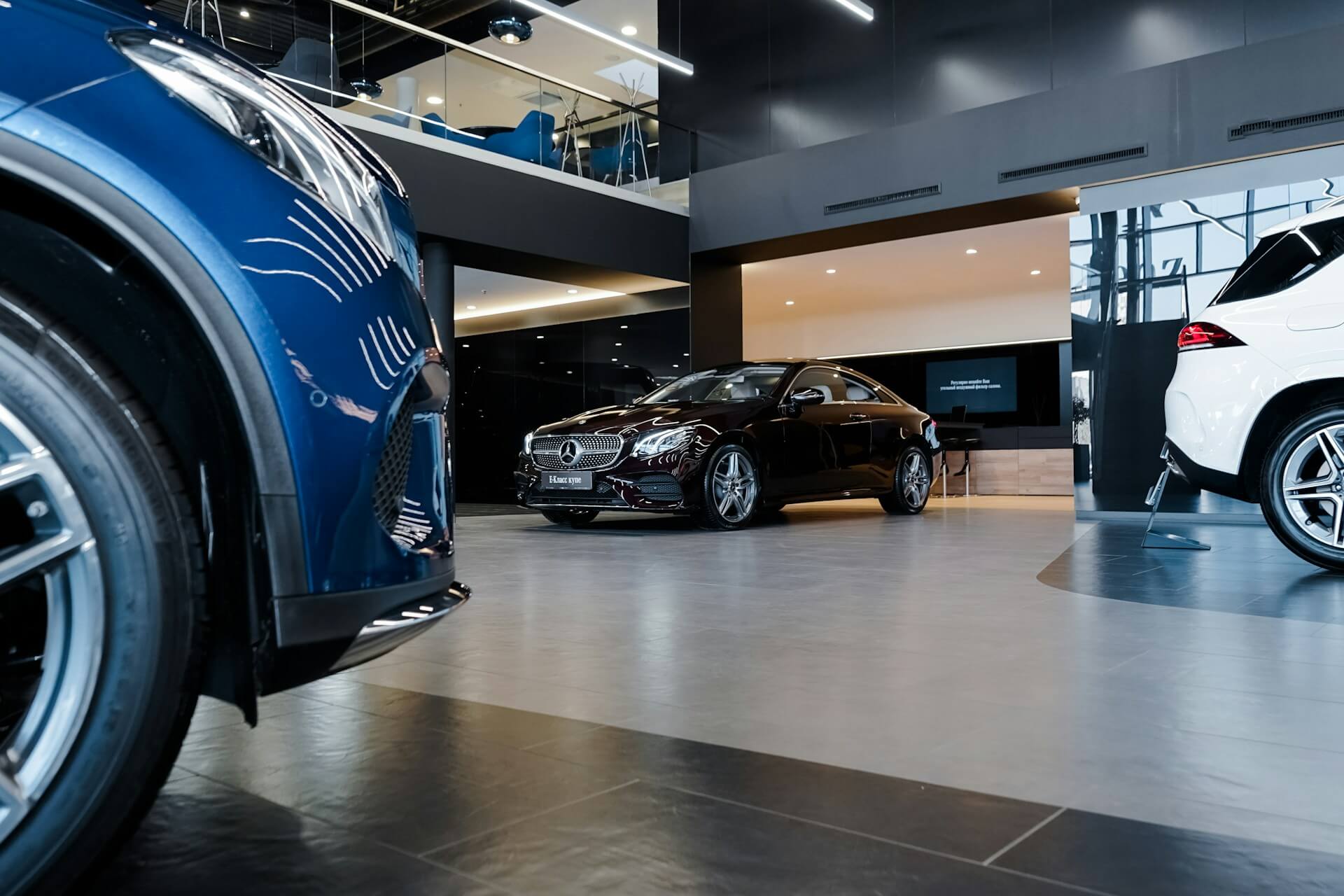 Black, white and blue Mercedes-Benz vehicles in a dealership