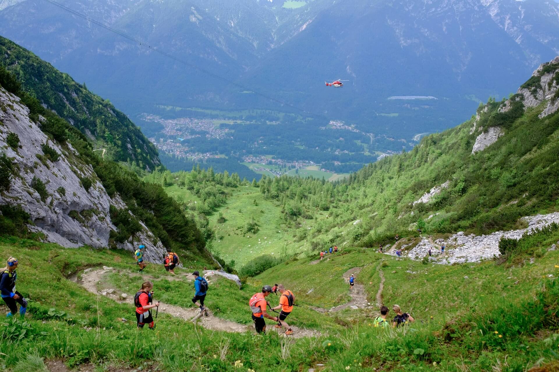 A group of fastpacking enthusiasts running downhill.