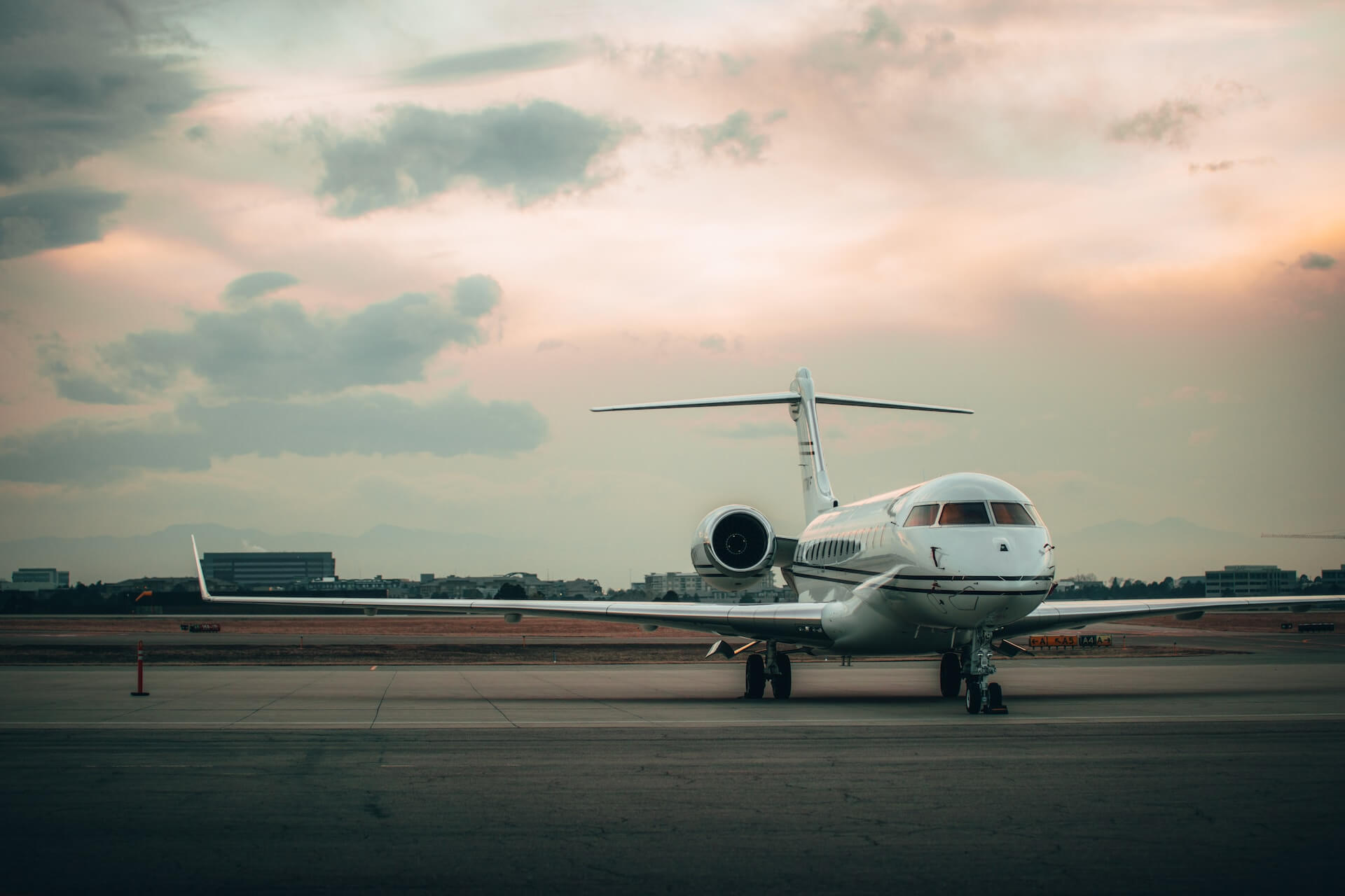 White plane on an airport runway.