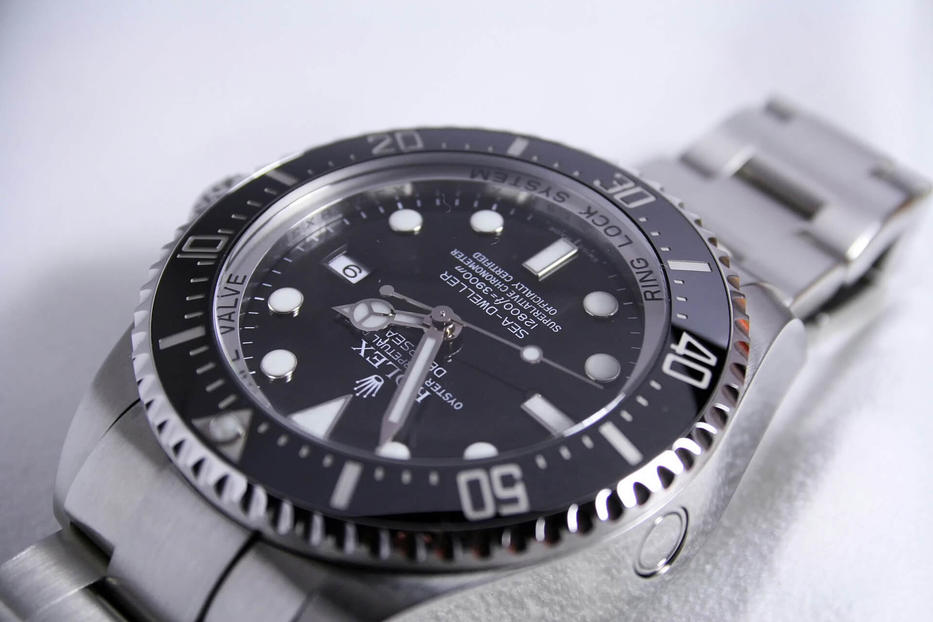 A close-up of a Rolex dive watch laid on a surface