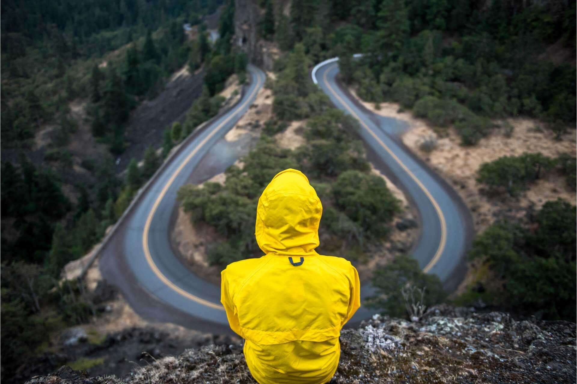 Man sitting on a cliff on his own