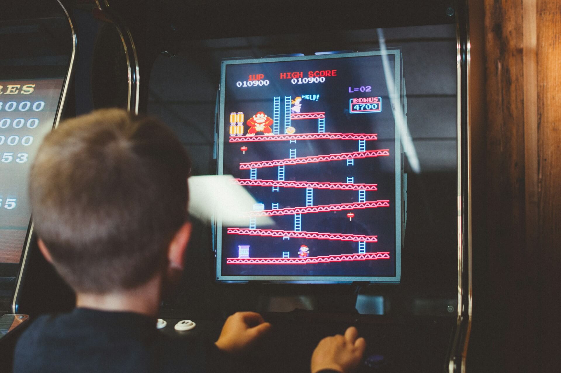 Boy plays Donkey Kong arcade game