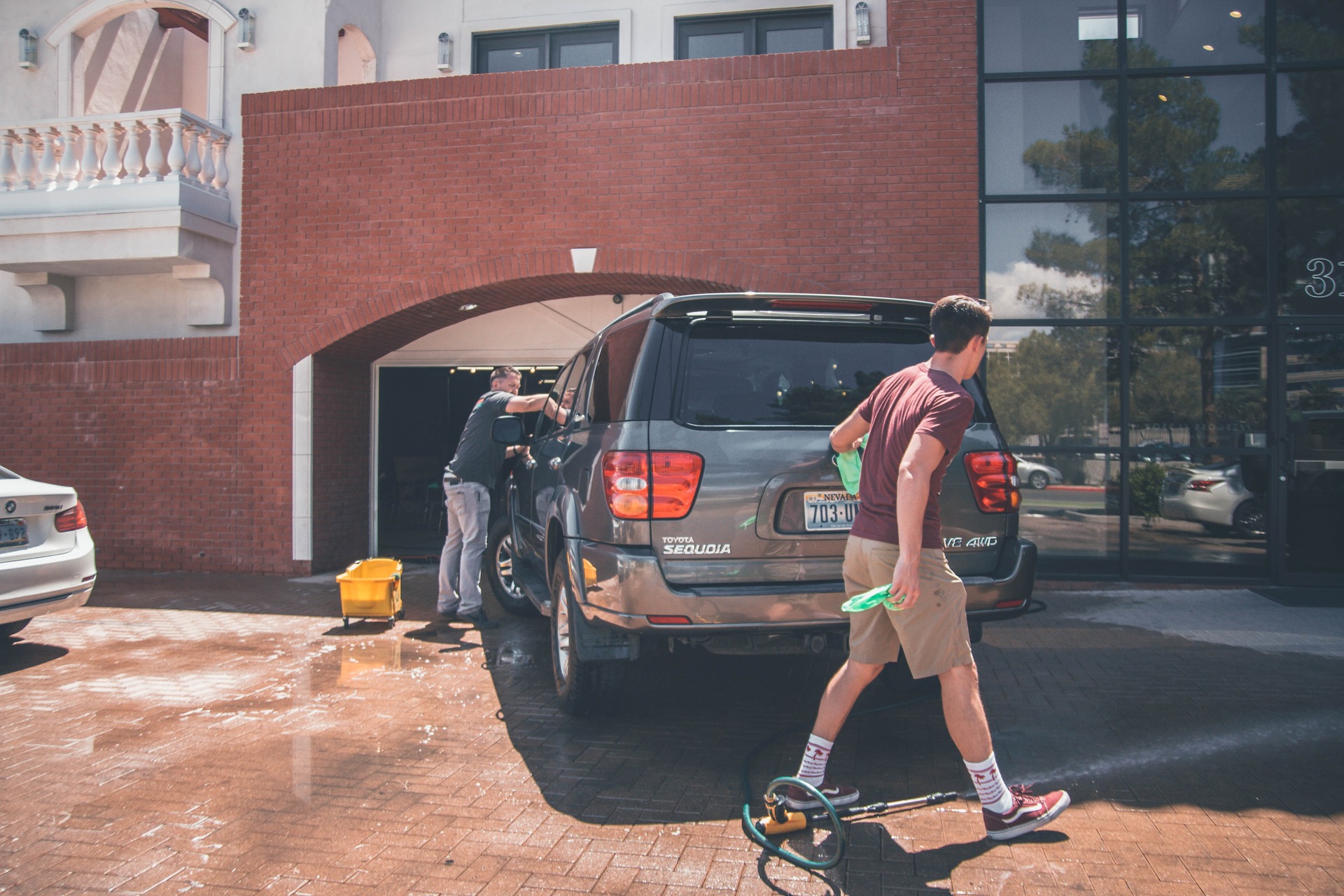 father and son washing their car