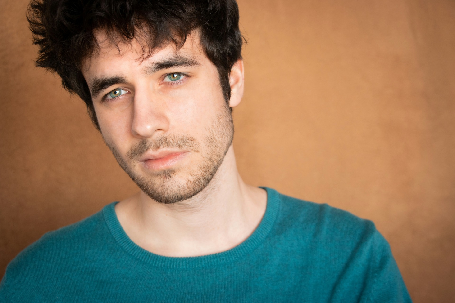 A young man with short stubble