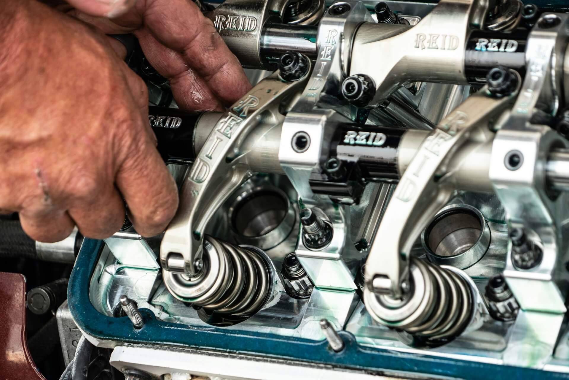 An automotive technician working on a car engine.