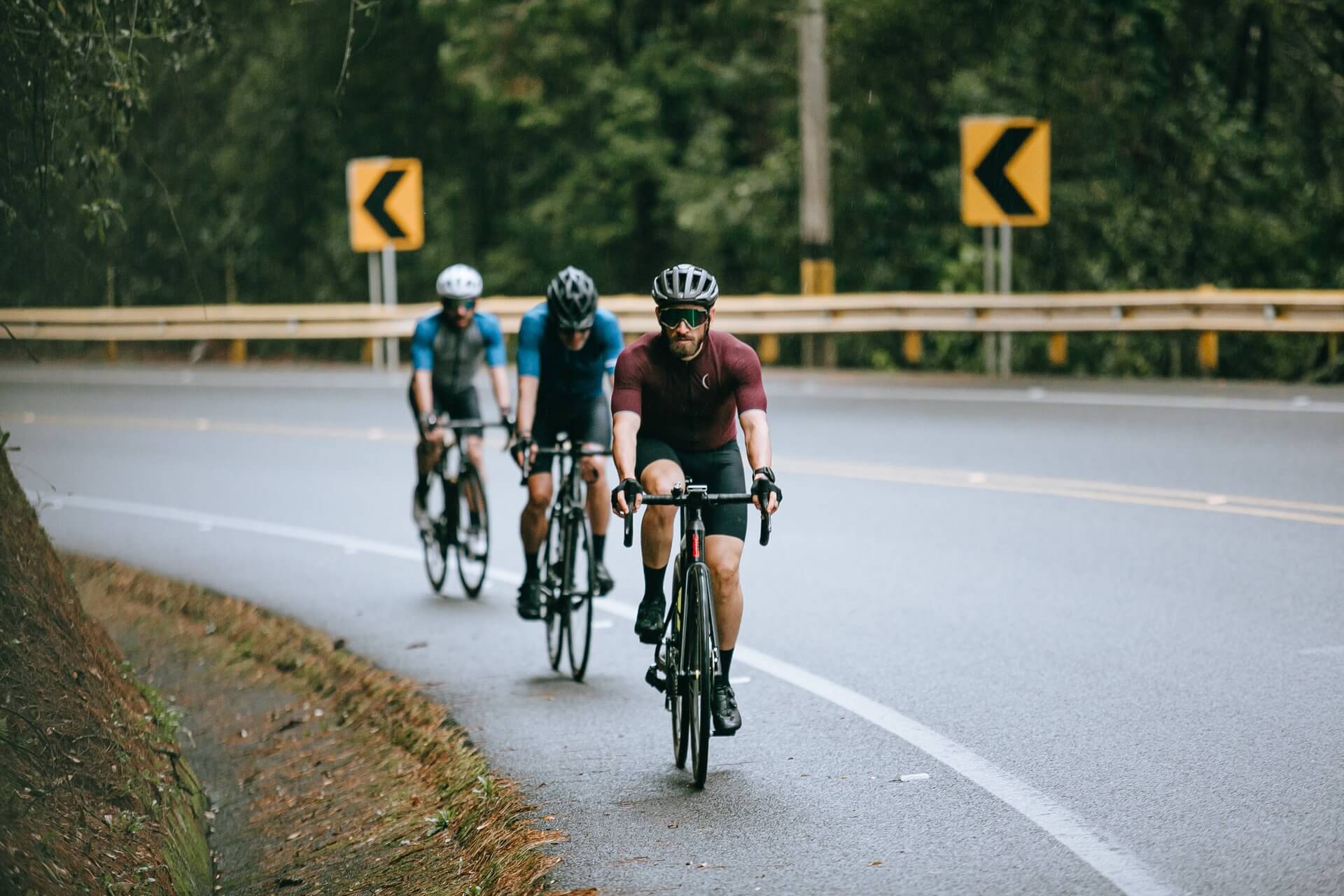Three cyclists riding uphill