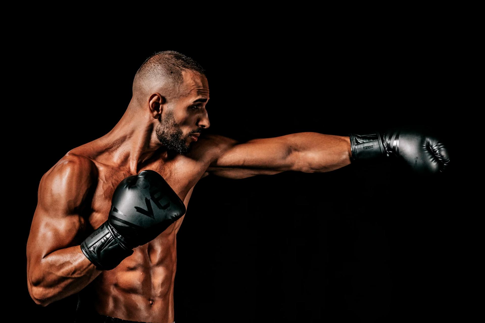 topless man with short hair and beard boxing