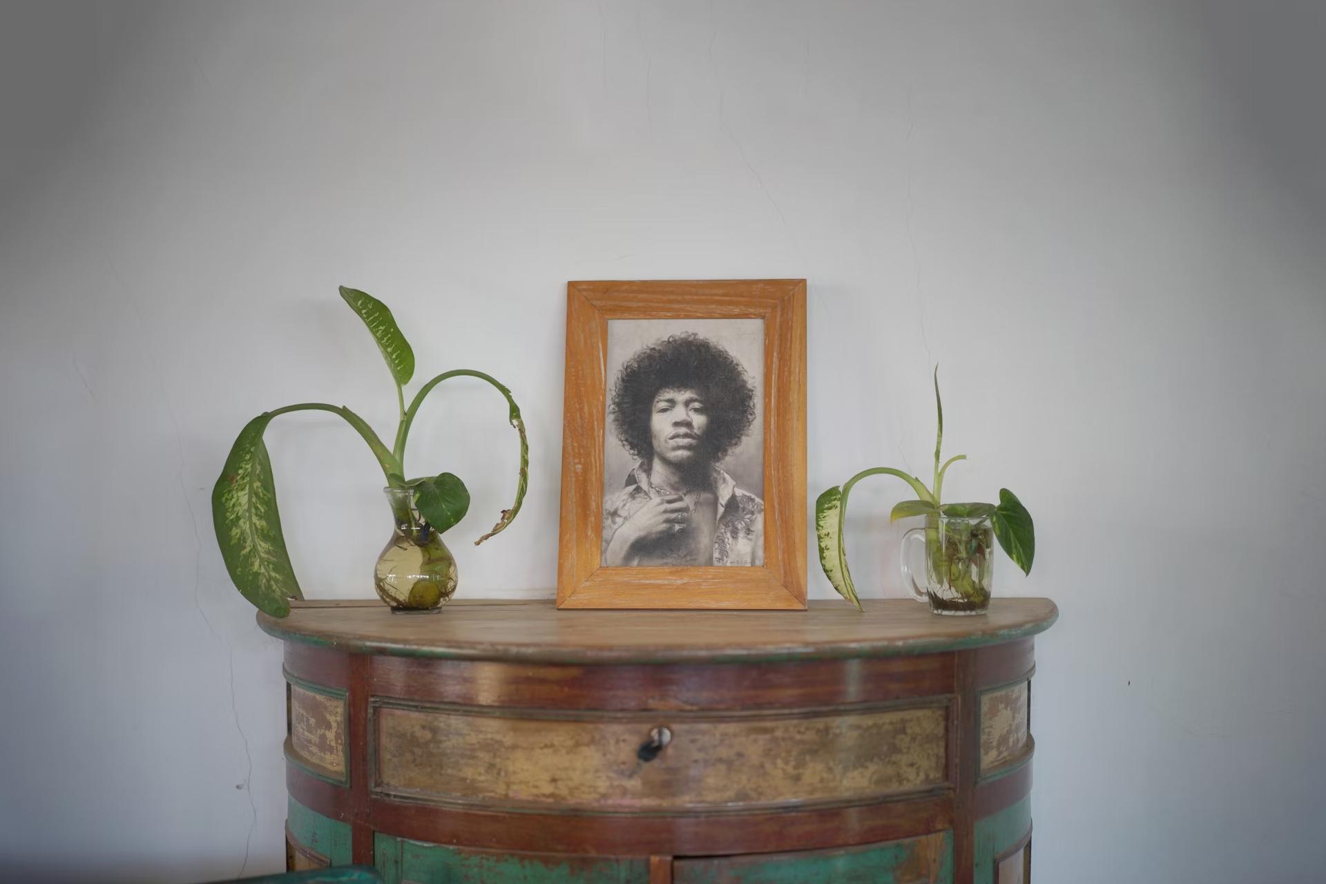 picture of man with afro in cabinet in front of white wall