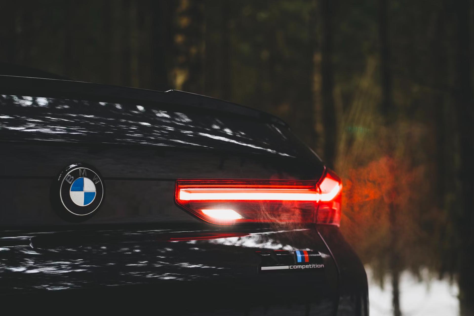 Rear view of black car with taillight and BMW logo