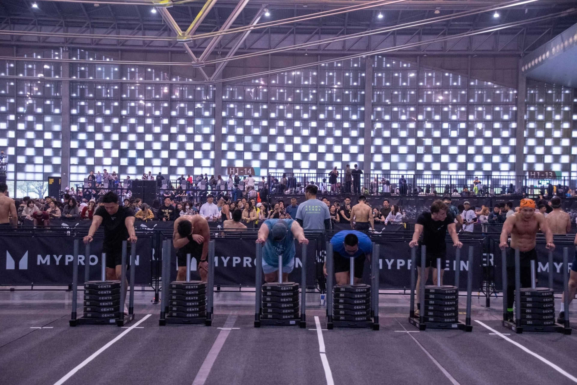 hyrox athletes pushing weighted sleds