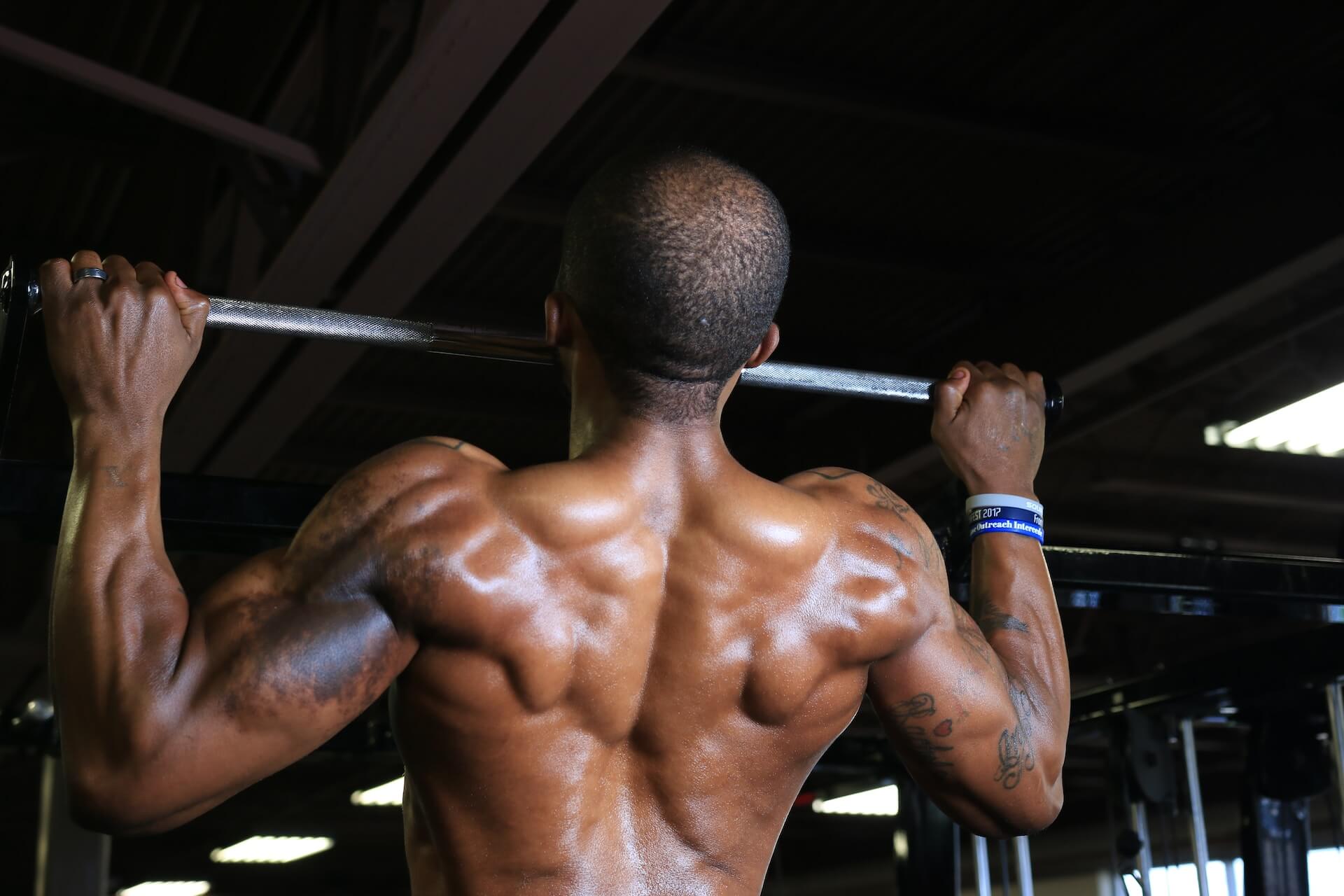 Man doing a pull-up at a gym