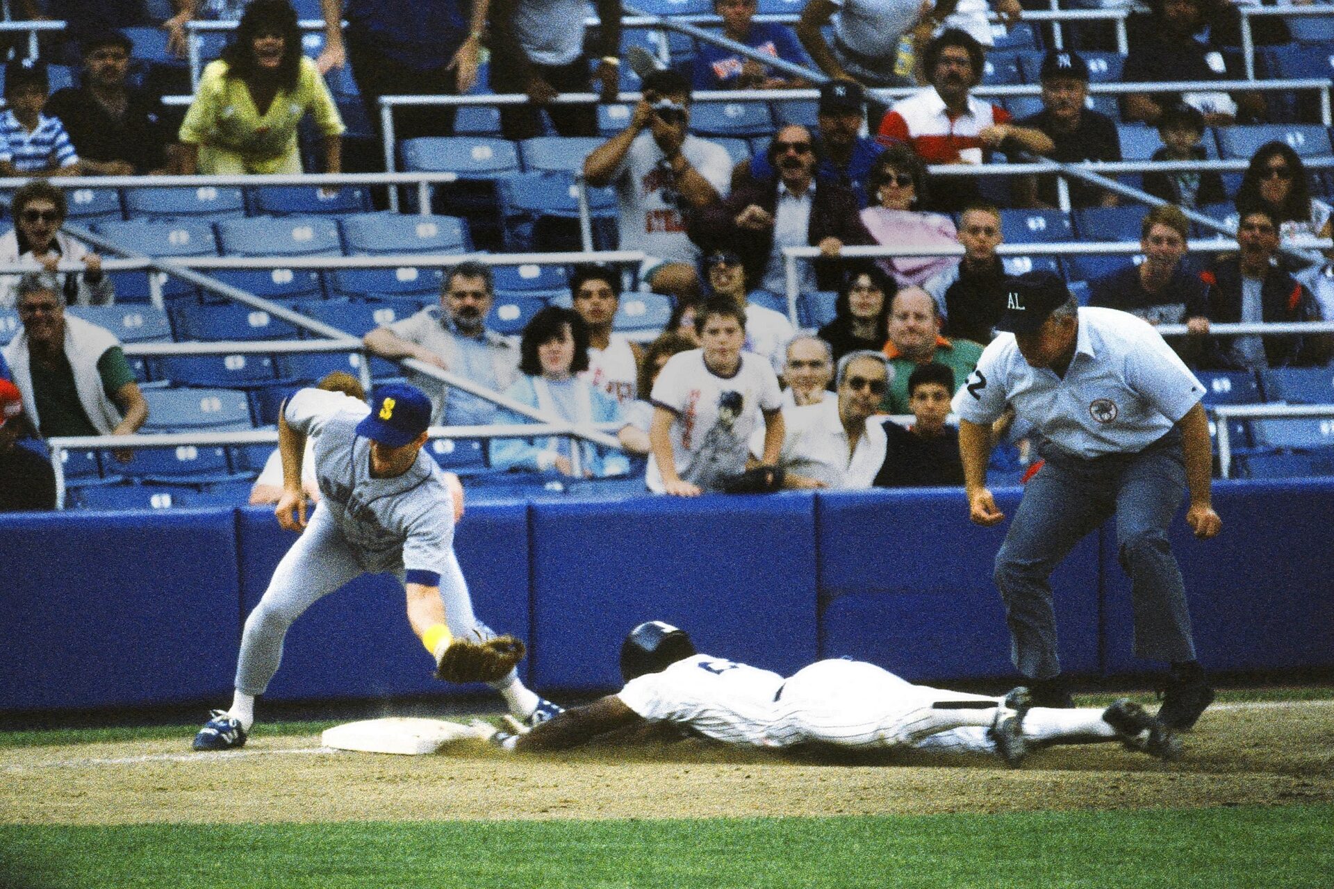Rickey Henderson sliding toward home
