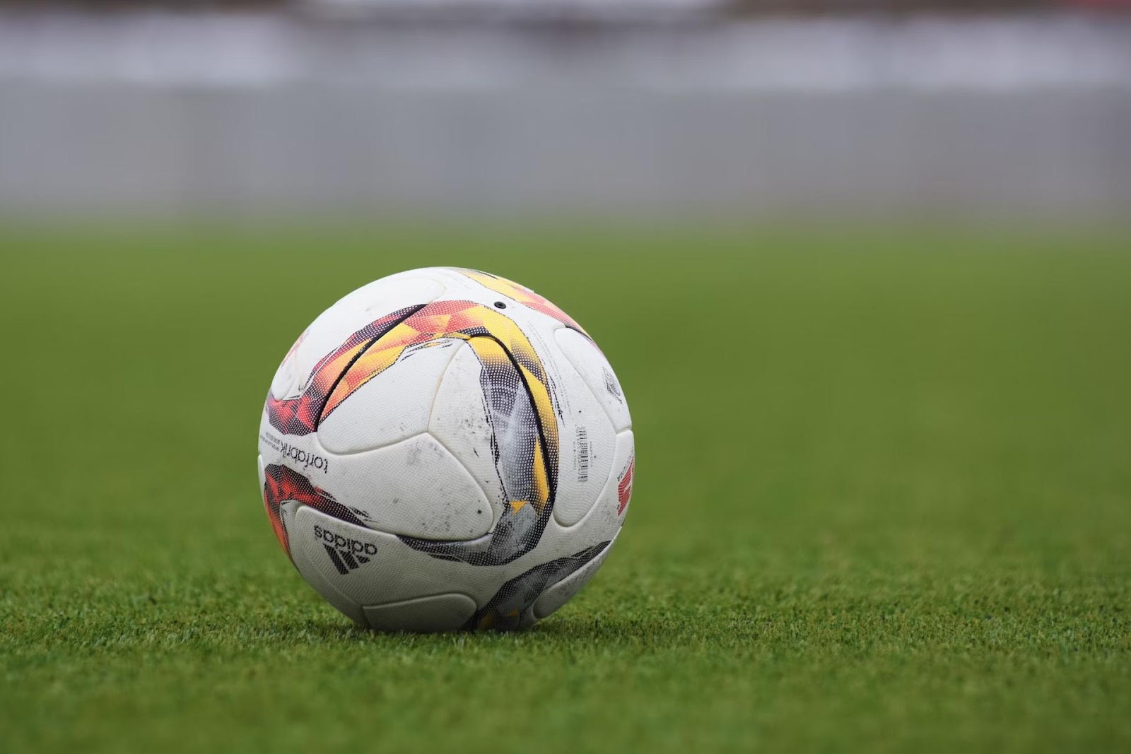Adidas football on field