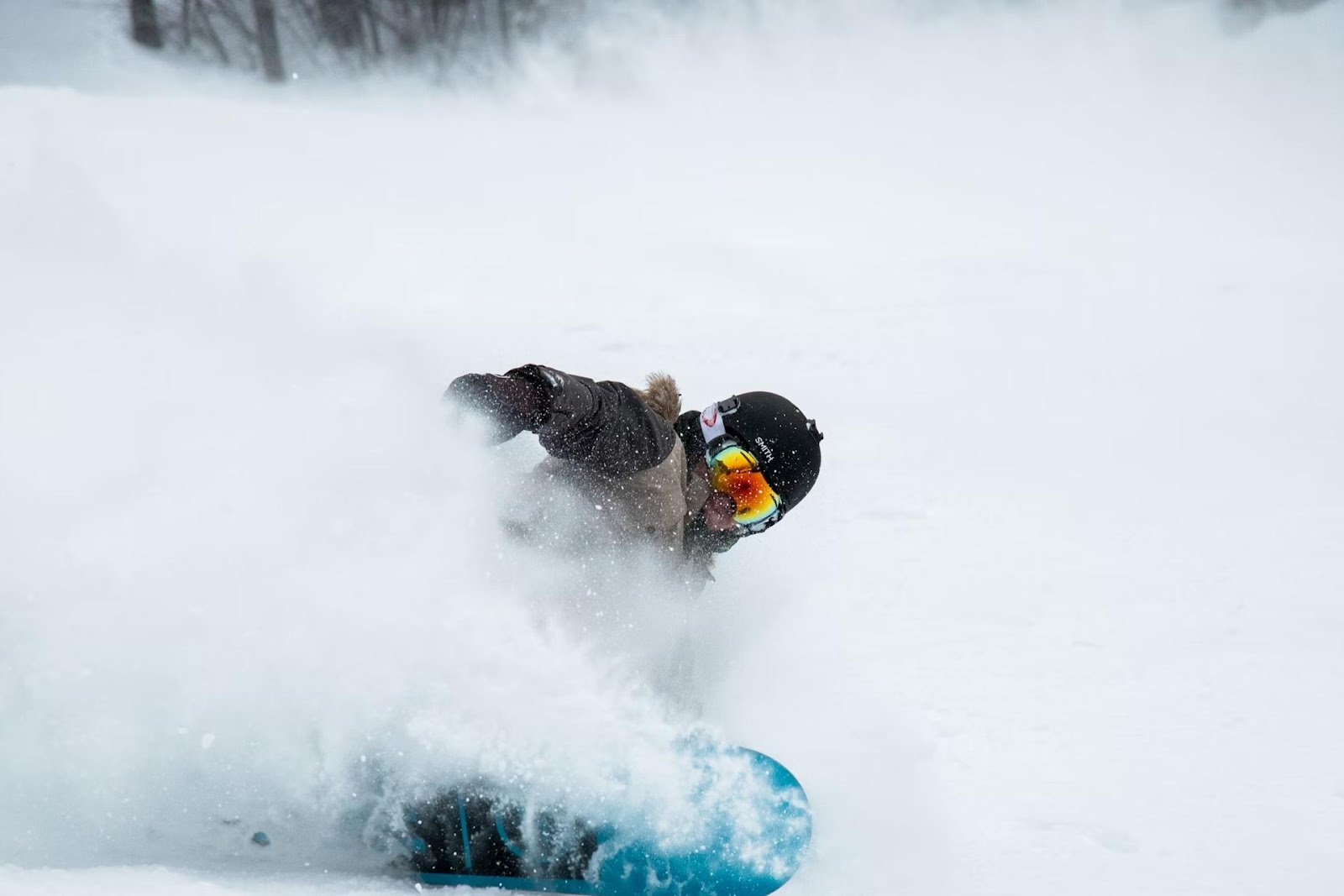 snowboarder in snow with bright goggles