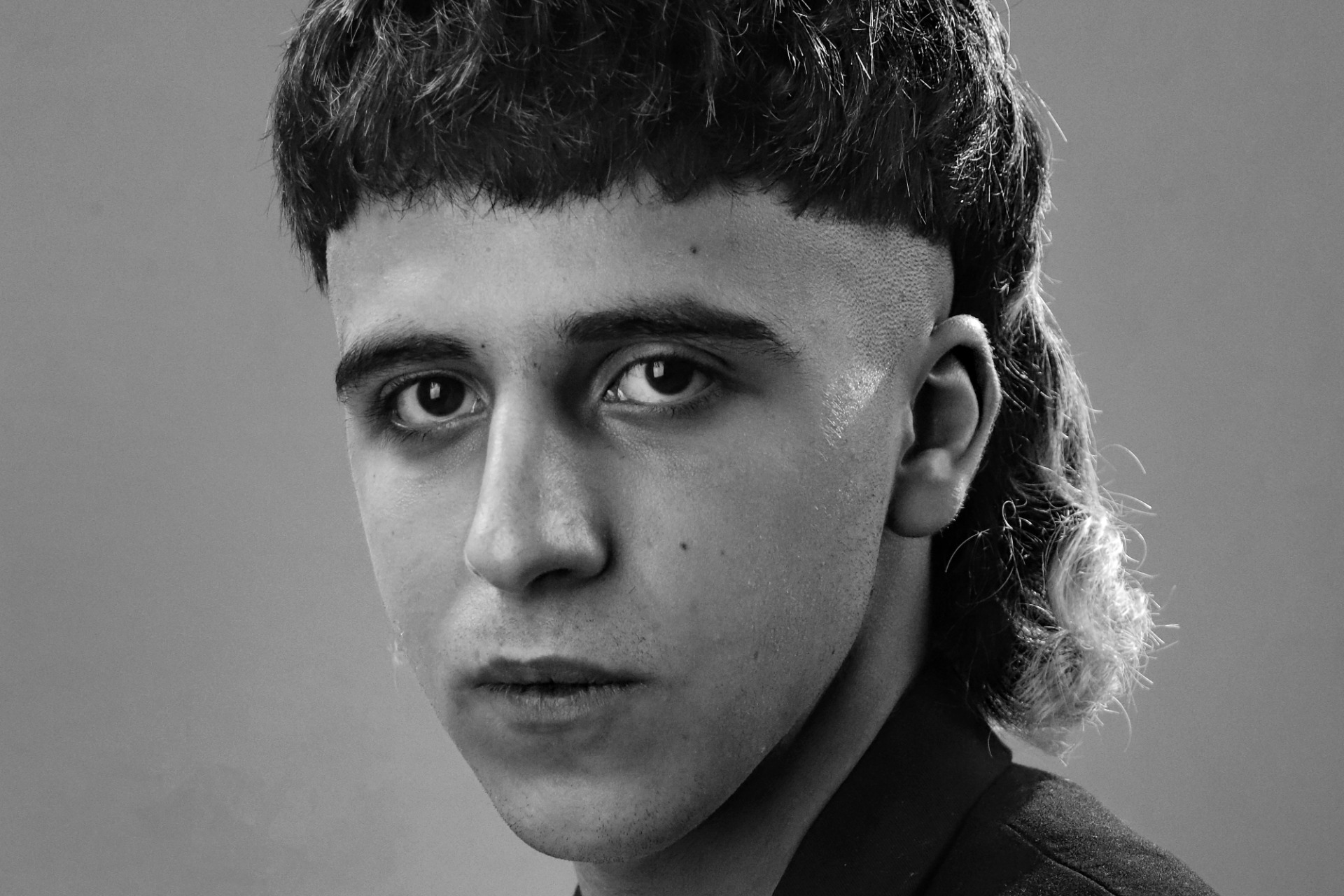 Young man with a modern mullet haircut