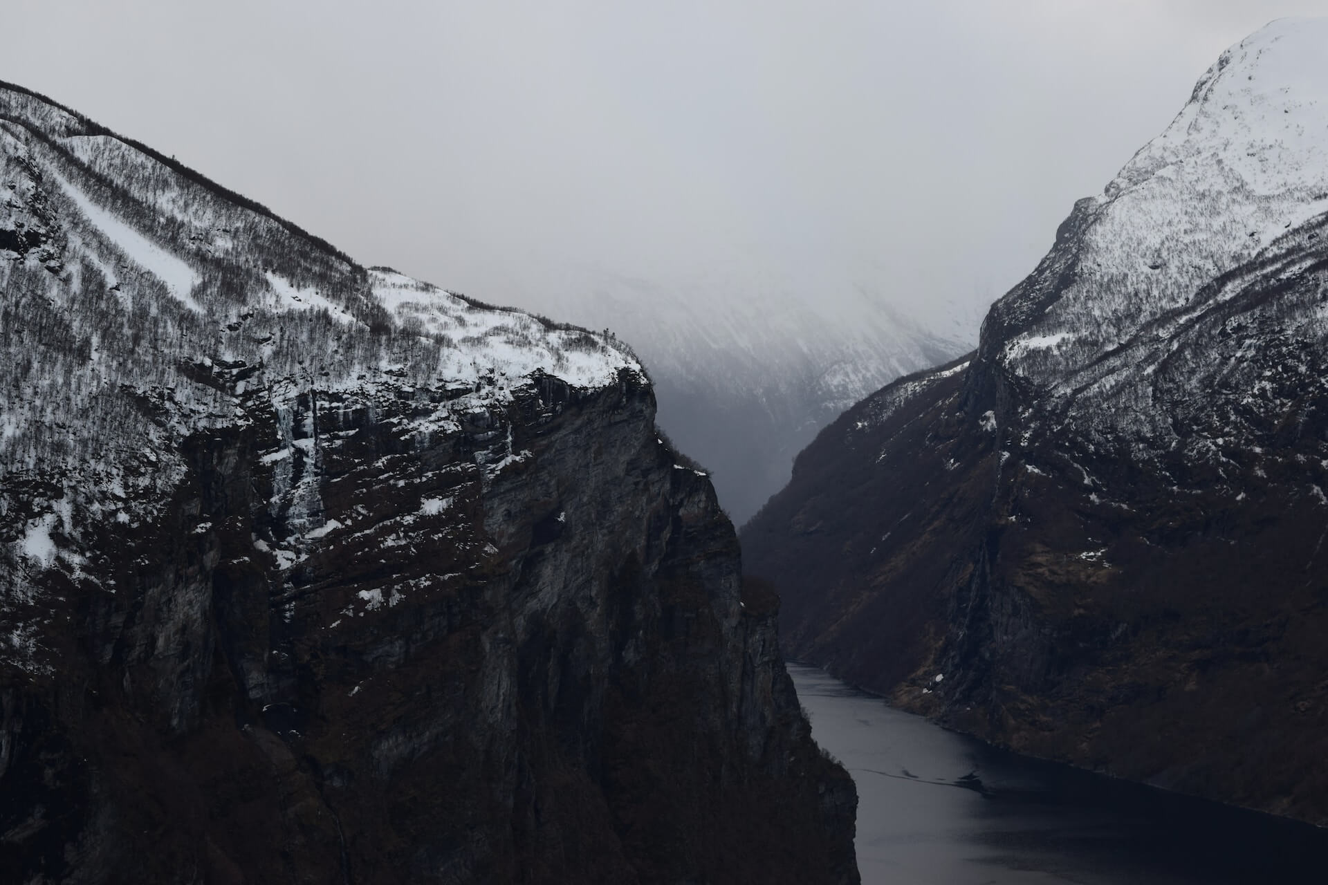 Norwegian fjord covered with snow in the winter - AI game.