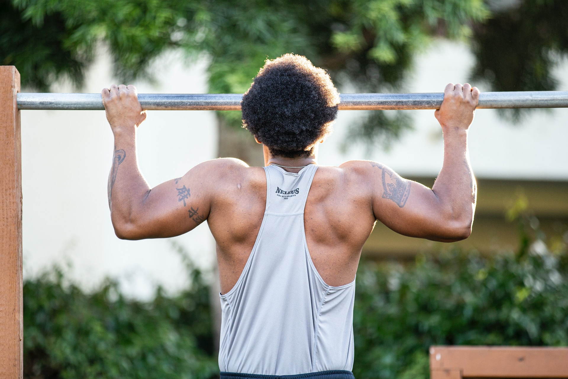 A man using a pull up bar stand