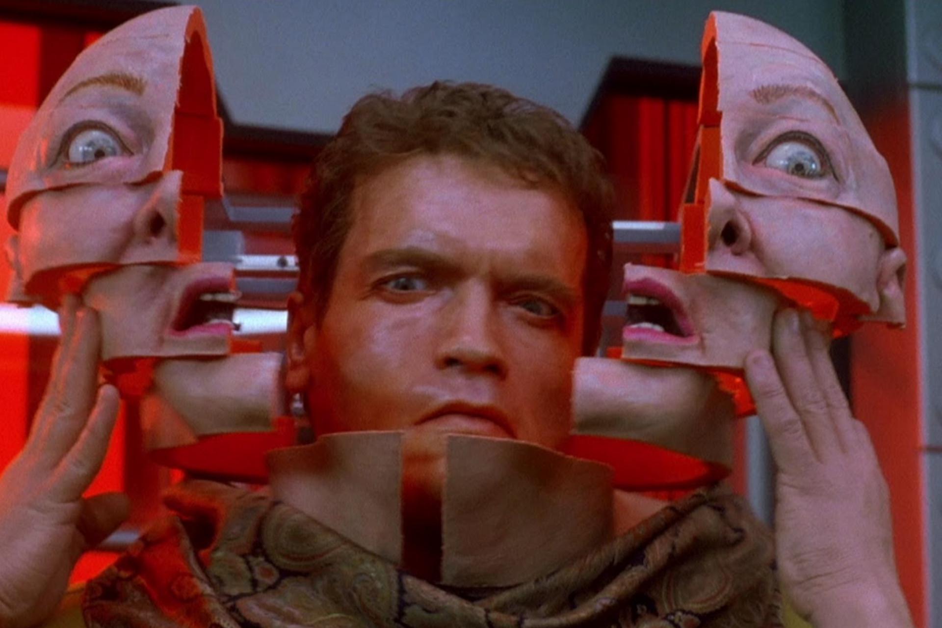 Frowning man holding semi-detached face mask