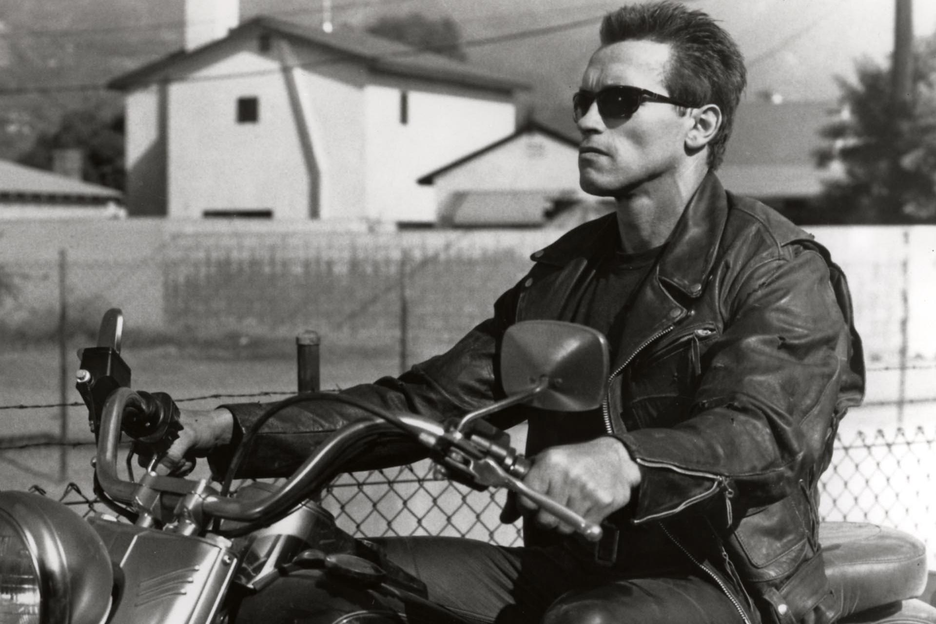 Grayscale man with sunglasses on motorcycle