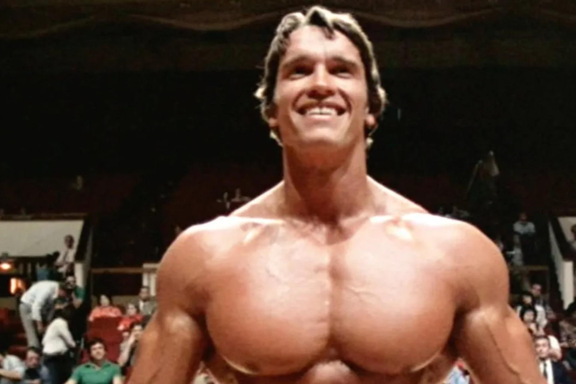 Muscular man smiling with crowd behind him