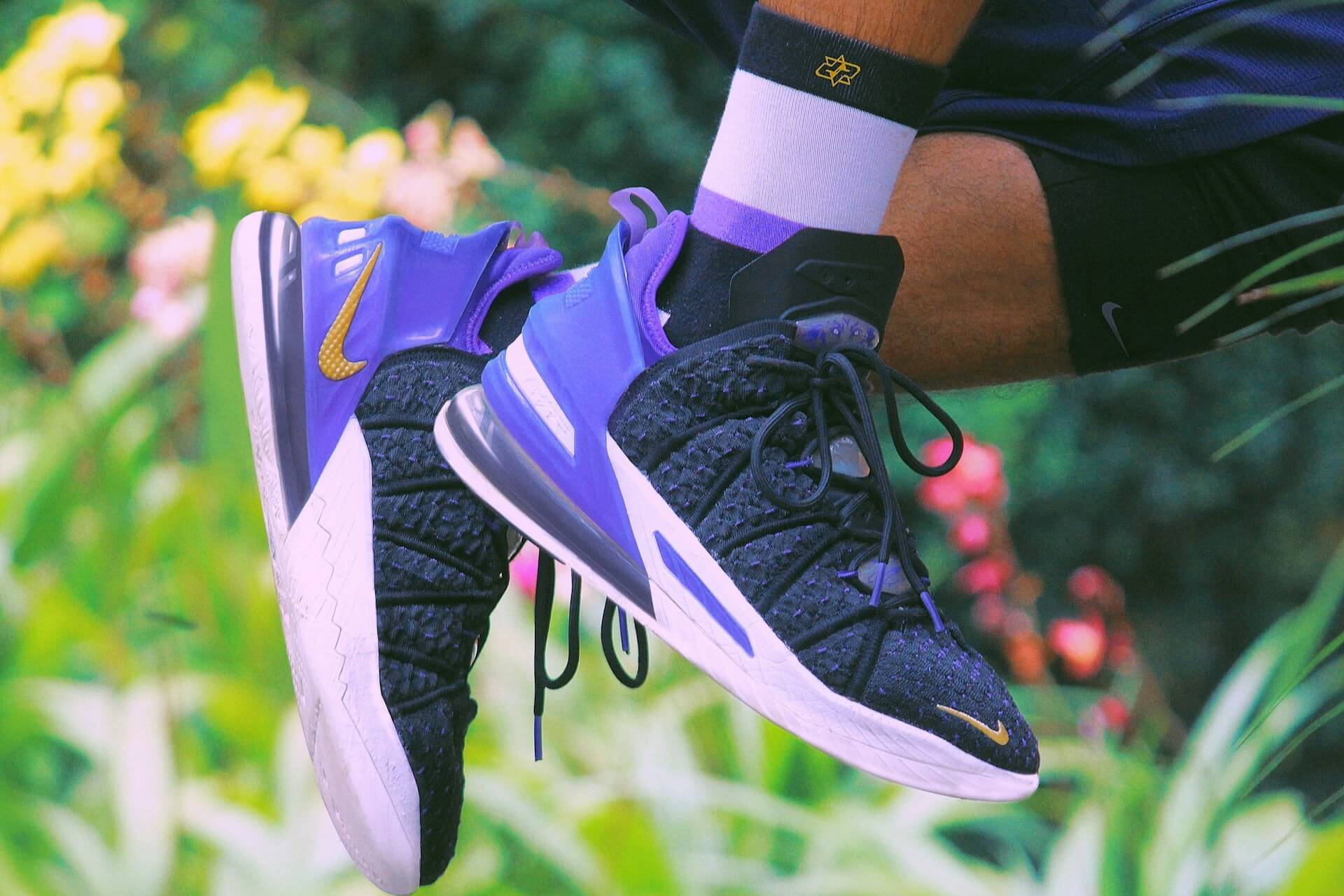 a person wearing a pair of Nike LeBron 18 Lakers