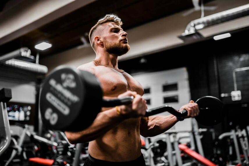 a bulky man lifting a 60 lb barbell