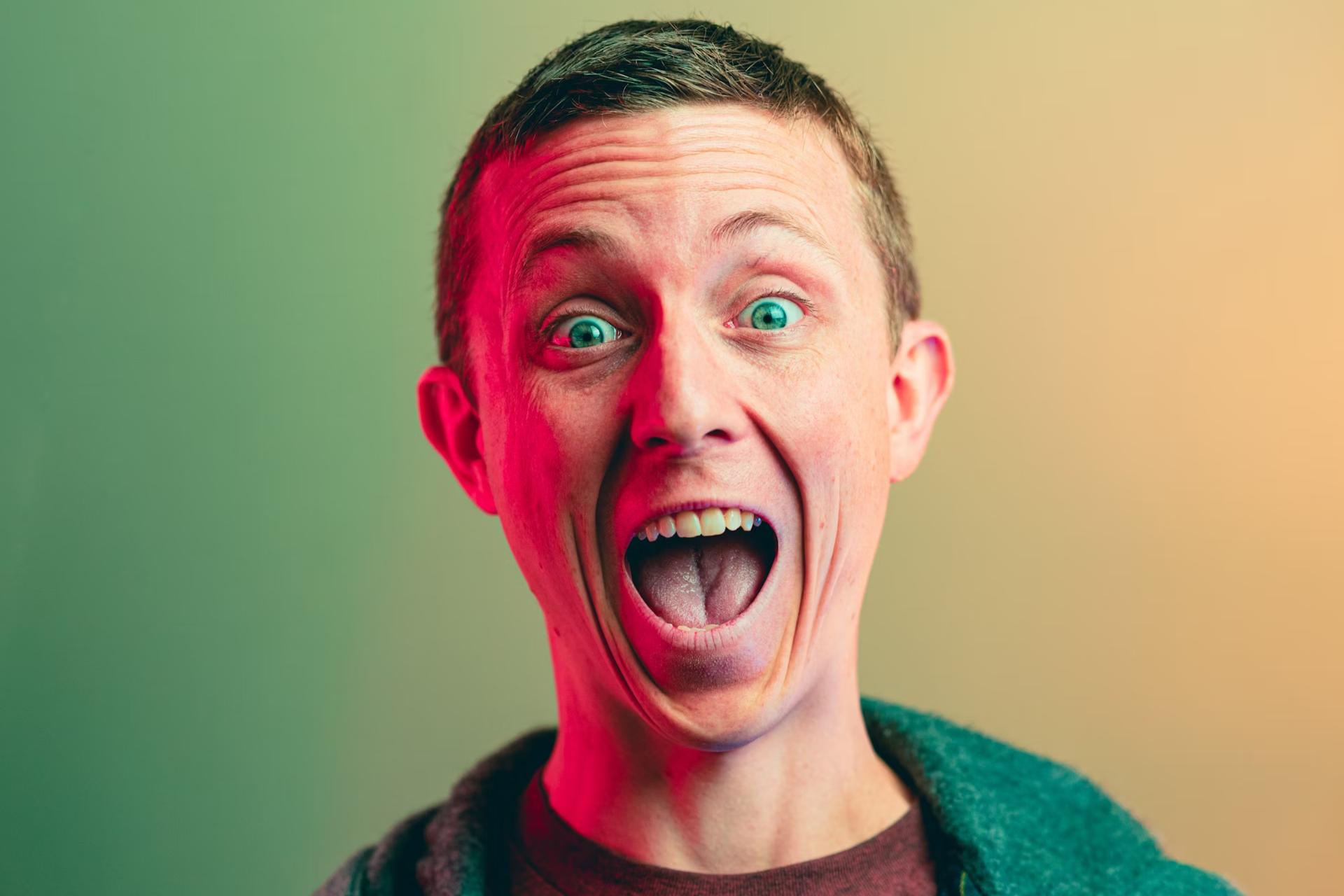 excited man with short hair and green top