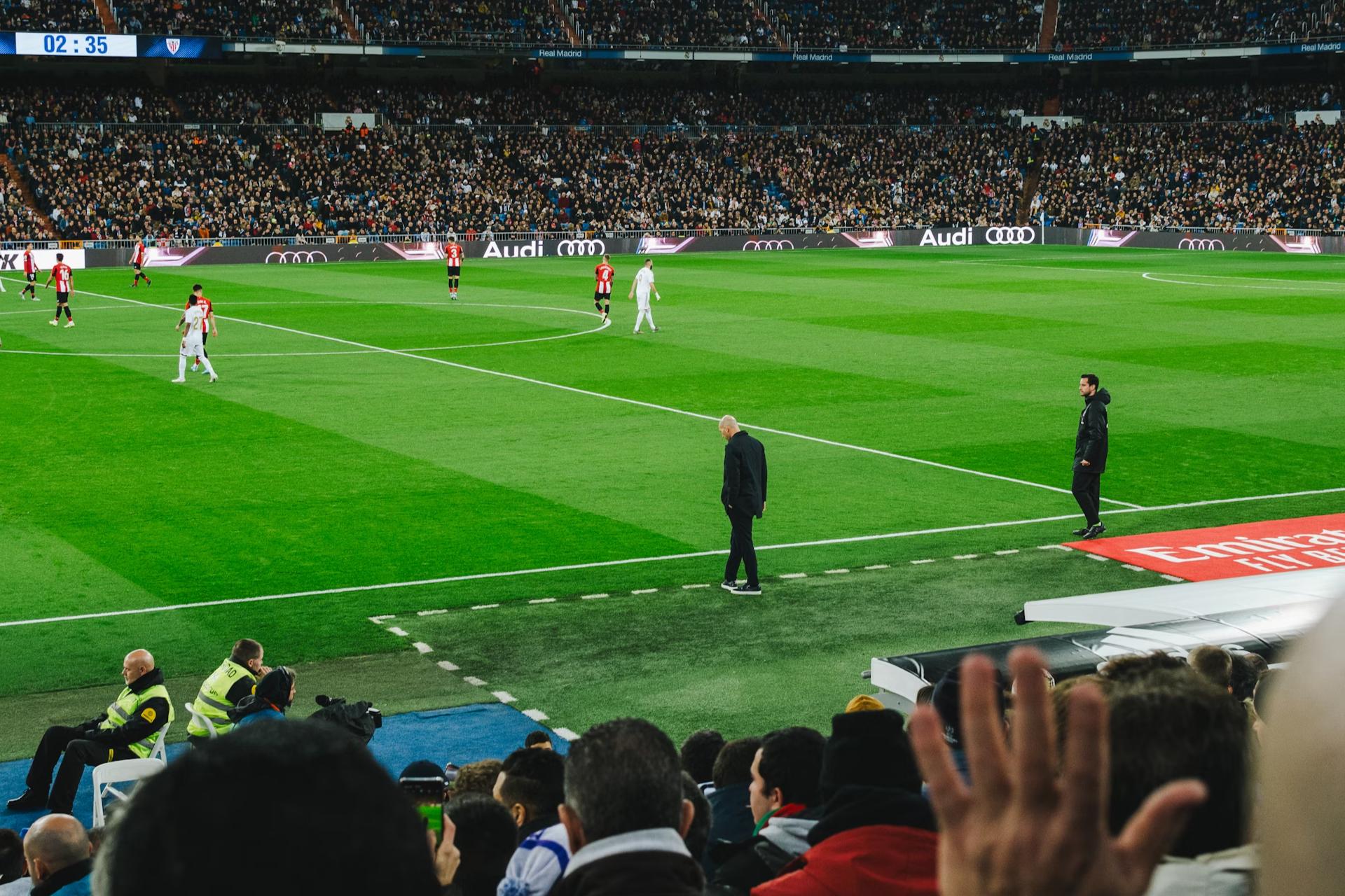 men in black near soccer pitch