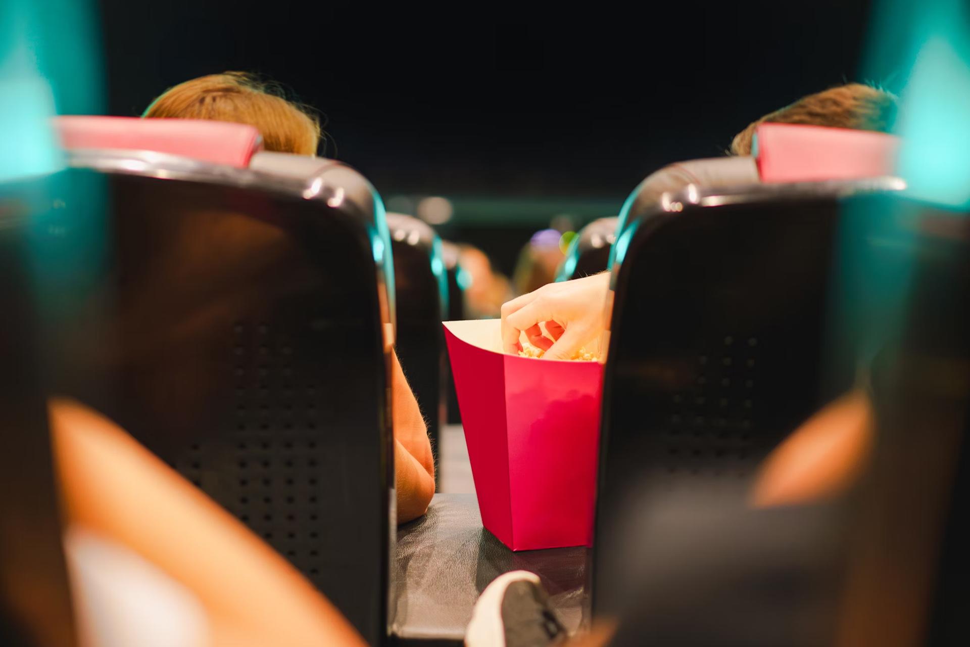 a person in a chair eating popcorn