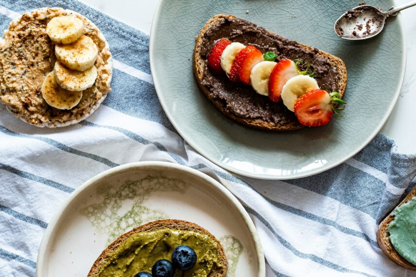 Simple carb foods, including bread, peanut butter and bananas on a plate
