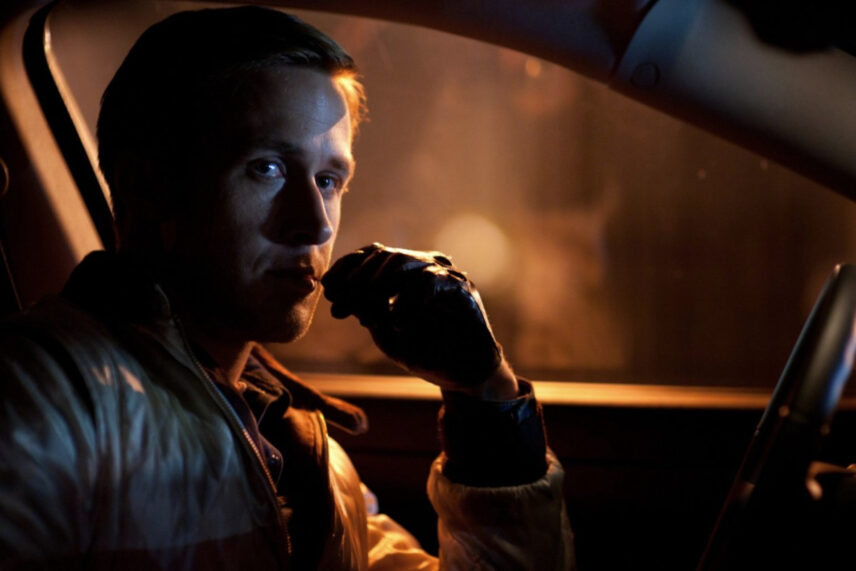 man sitting in car in shadows