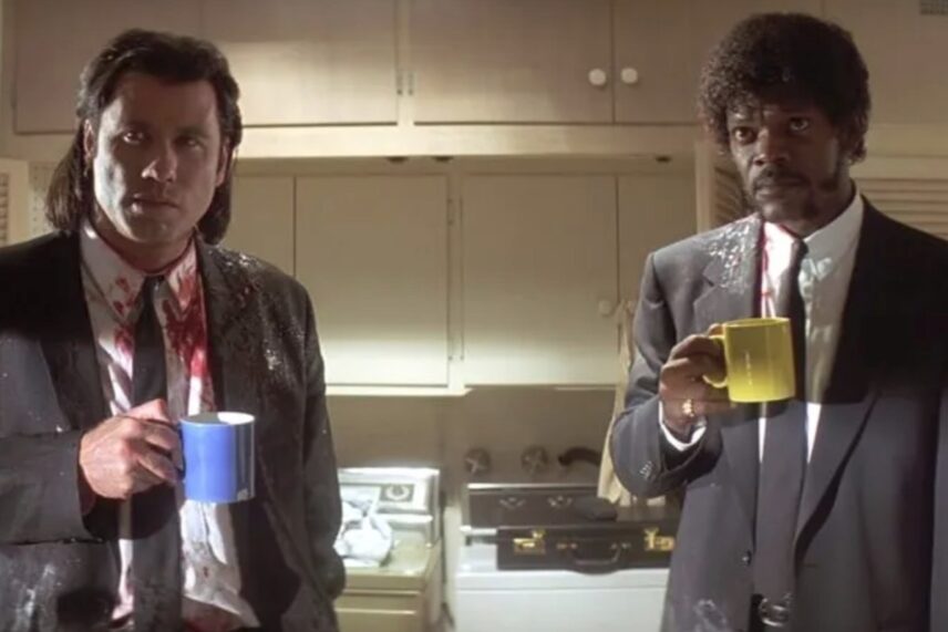 two men in black holding cups