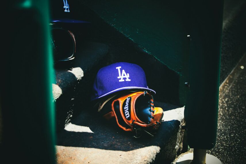 Los Angeles Dodgers hat and glove sitting in the dugout